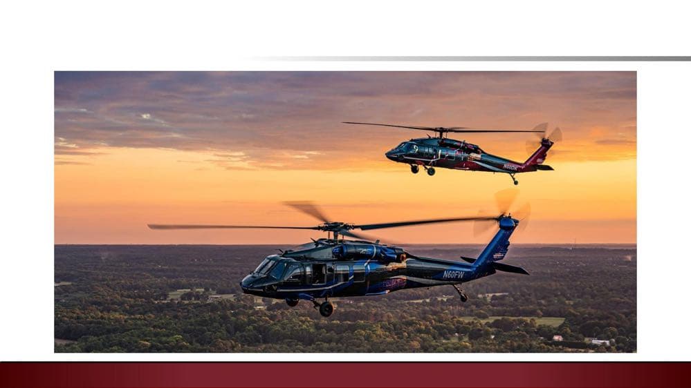 UH-60 Black Hawk helicopters in flight at sunset